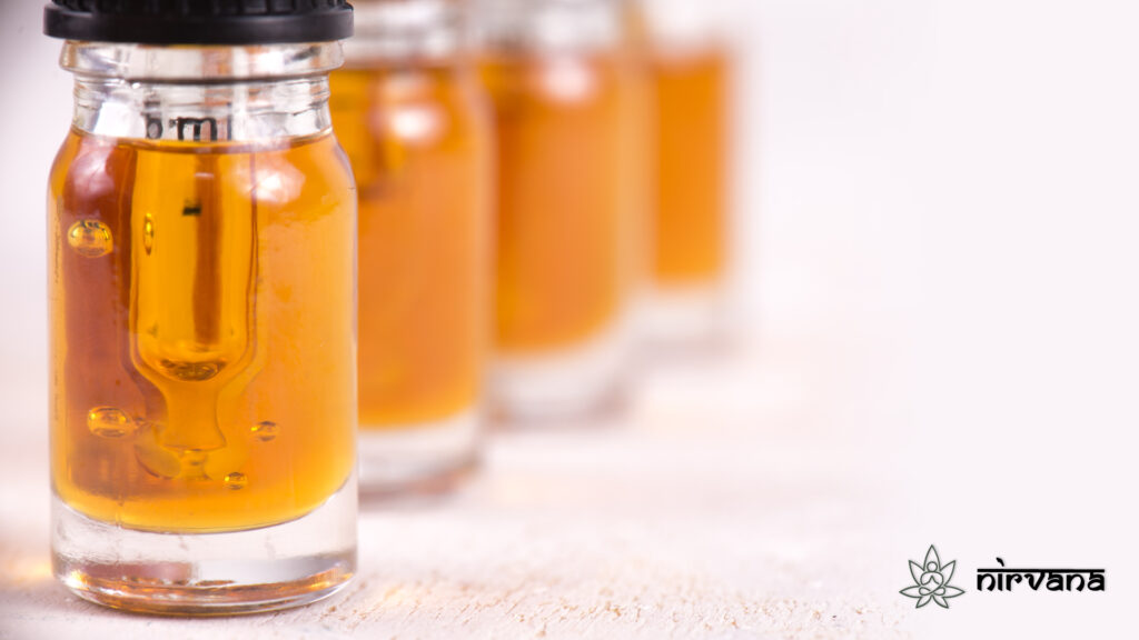 Close-up of glass vials filled with golden cannabis oil, highlighting purity and quality.